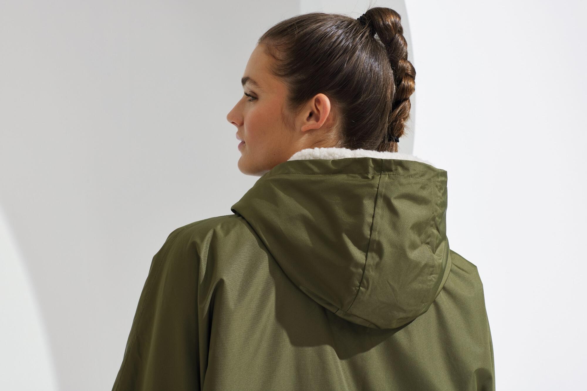 All-seasons waterproof changing robe with a hood, adjustable straps, double zip closure, and multiple deep pockets, featuring a waterproof exterior and cosy sherpa fleece interior.