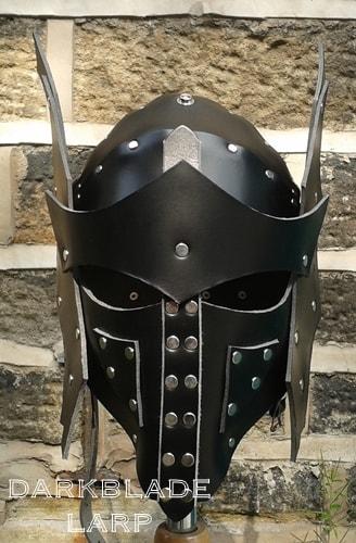 A full face helmet with leather wings attatched to the side.