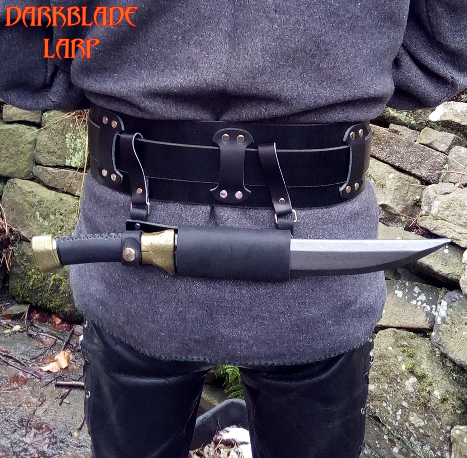 A dagger scabbard attached horizontally to the belt