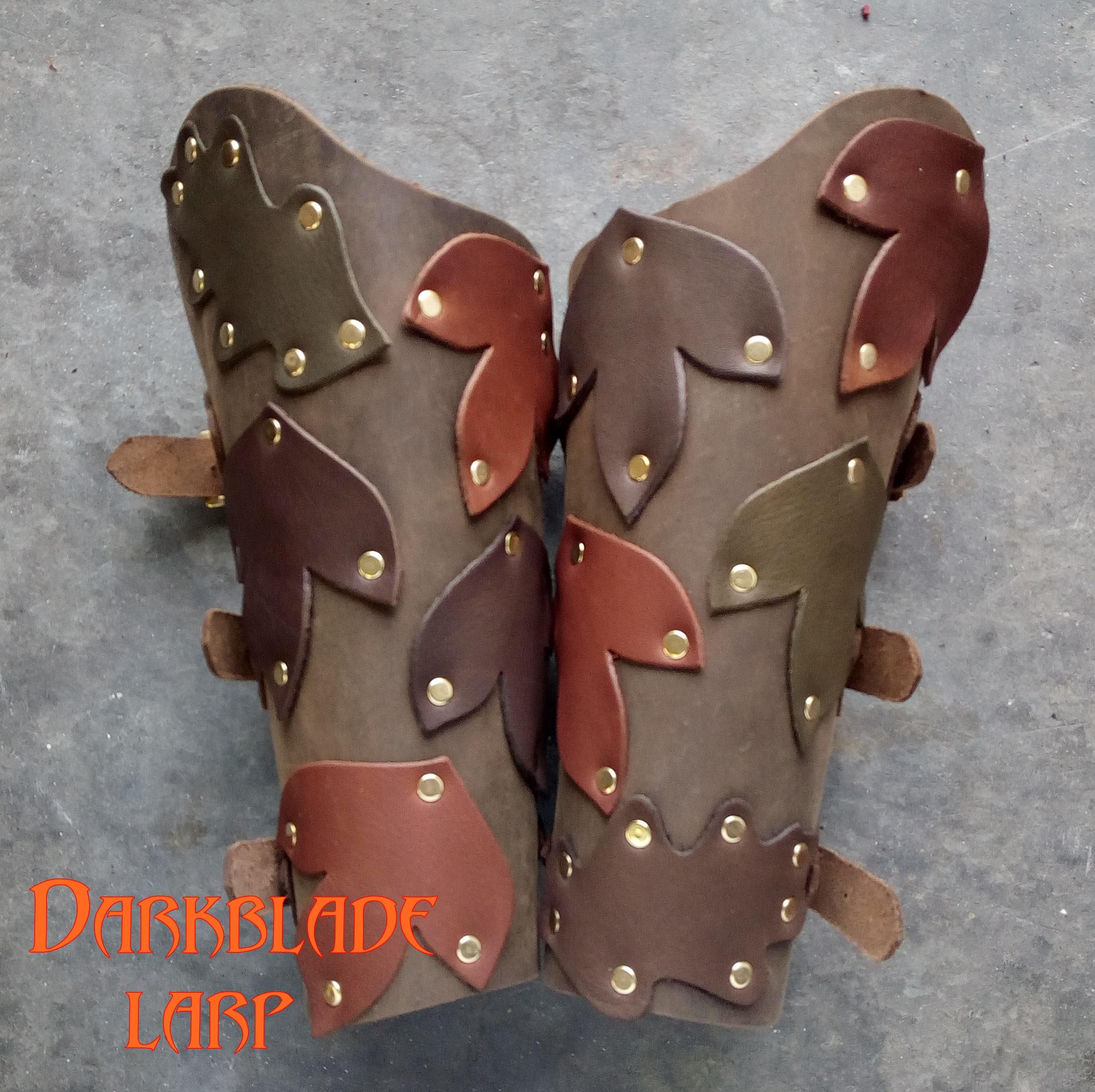 leather vambraces decorated with suede leaves