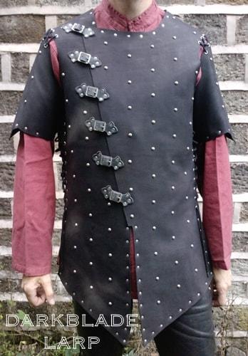 suede jacket with an assymetrical fastening covered in small domed studs