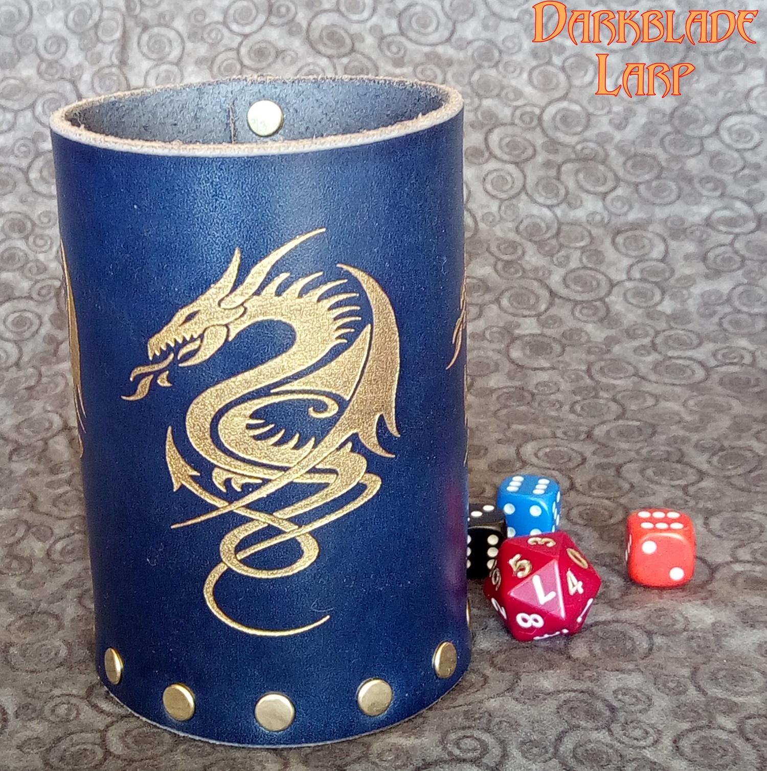 A blue leather cup with a golden dragon engraved on the front