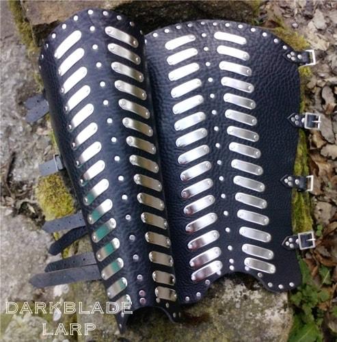 heavy leather greaves with metal plates riveted on