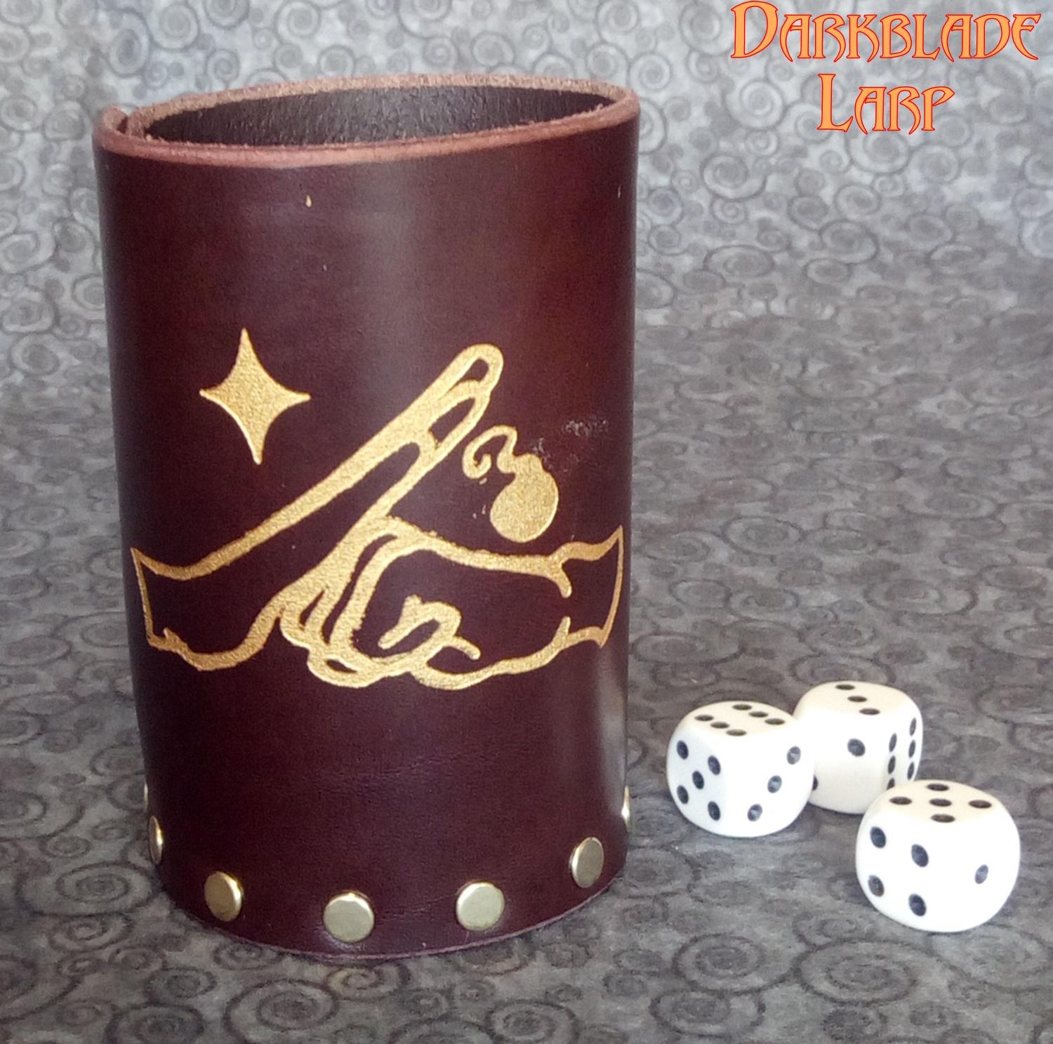 a leather dice cup engraved with a fist hitting an open palm