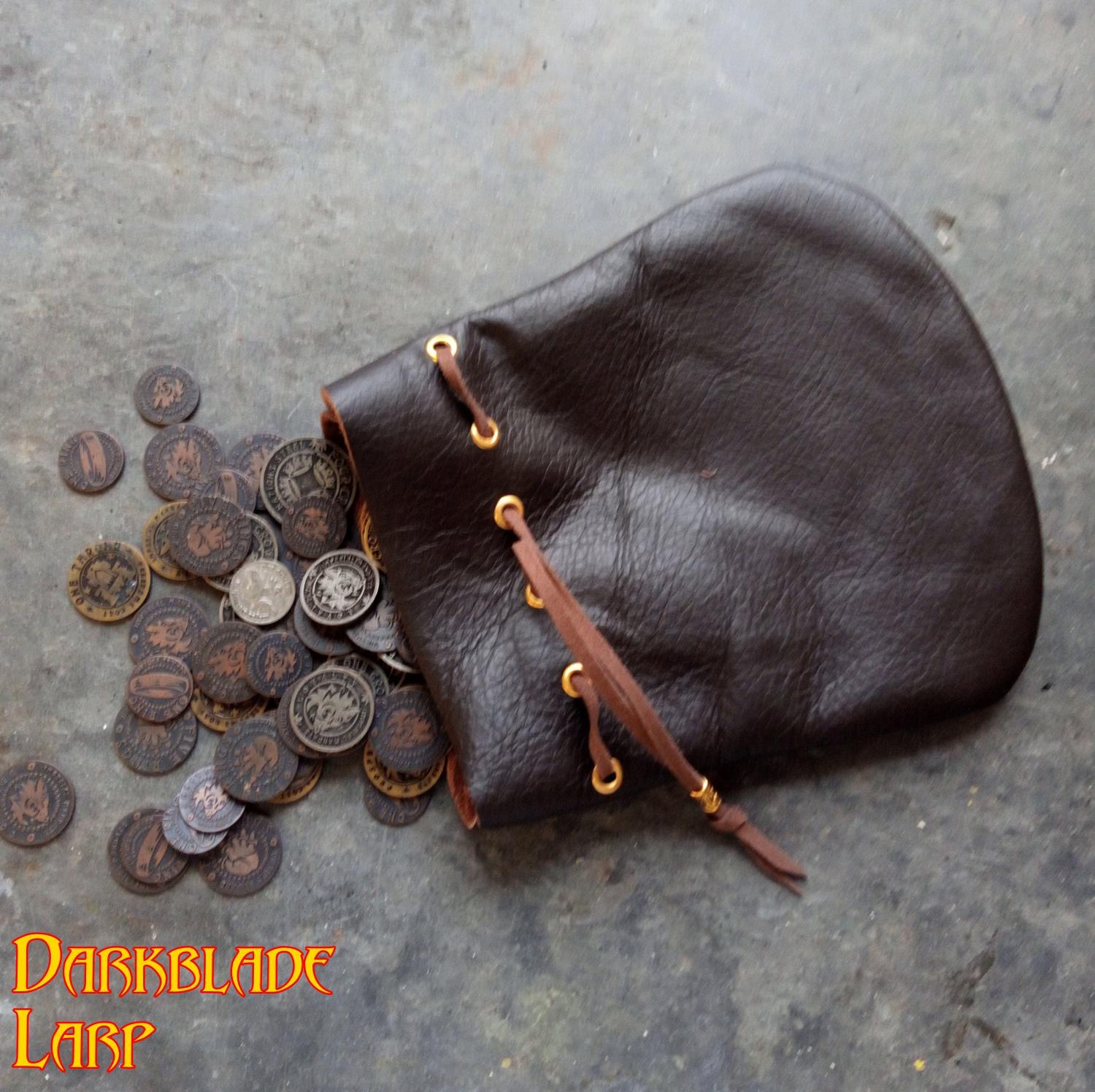 large leather drawstring pouch with coins spilling out