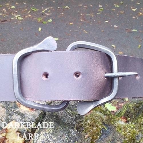 A belt with a buckle shaped like an open ended 8