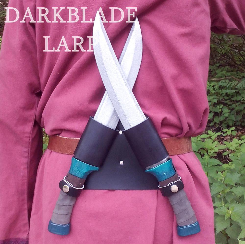 Twin dagger scabbard that sits at the small of your back