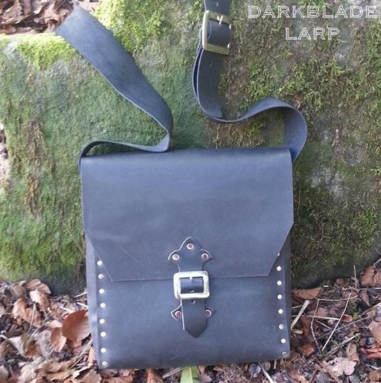 large leather satchel with riveted construction