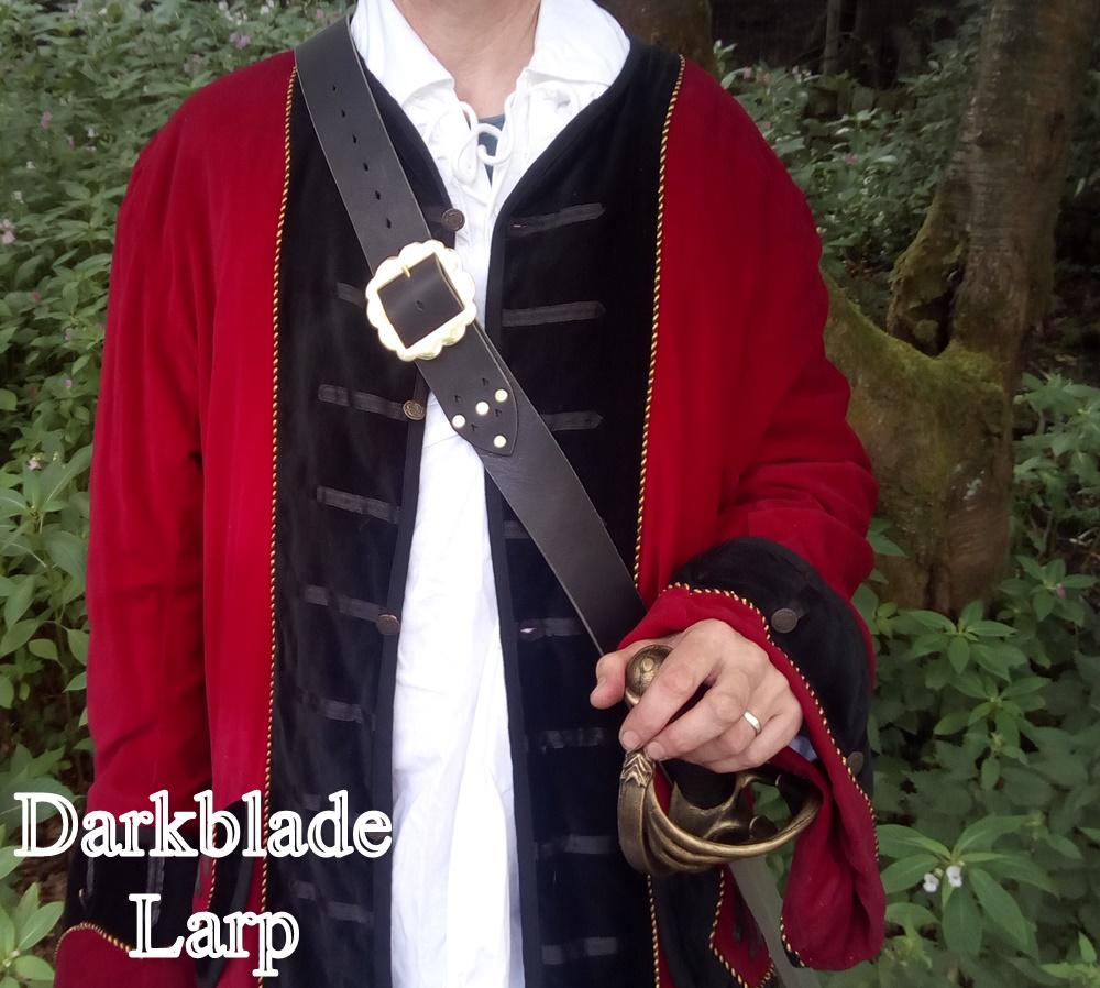 man in a frock coat with a leather baldric across his chest supporting a cutlass