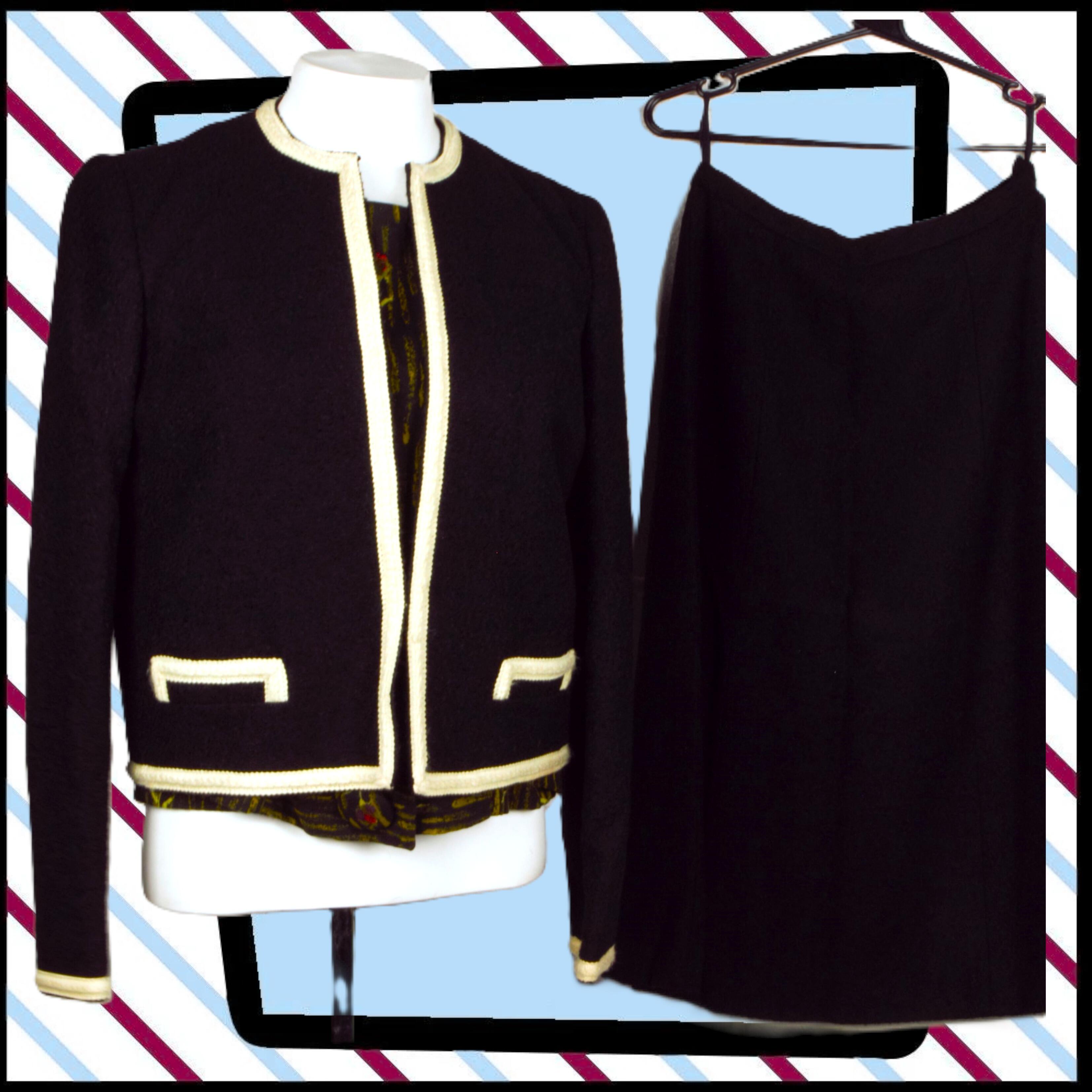a 2 piece suit with a stylish fitted jacket with a round neckline, hook and eye closure and a midi length A-line skirt with side zip