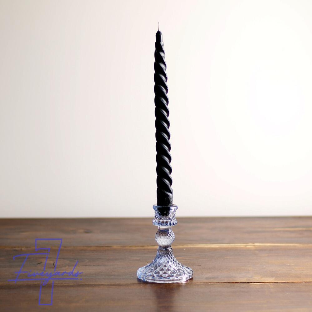 Small blue cut glass candle holder with black twist candle