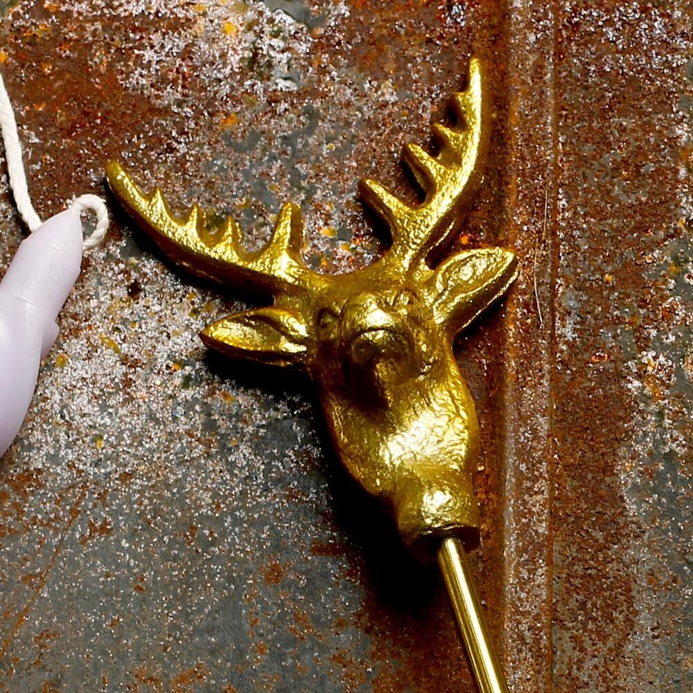 Candle snuffer with a gold rustic stags head