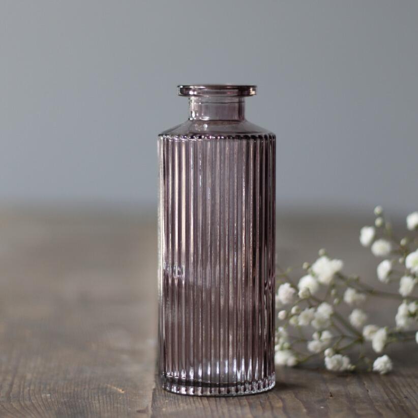 small decorative glass bottle  bud vase with with flowers