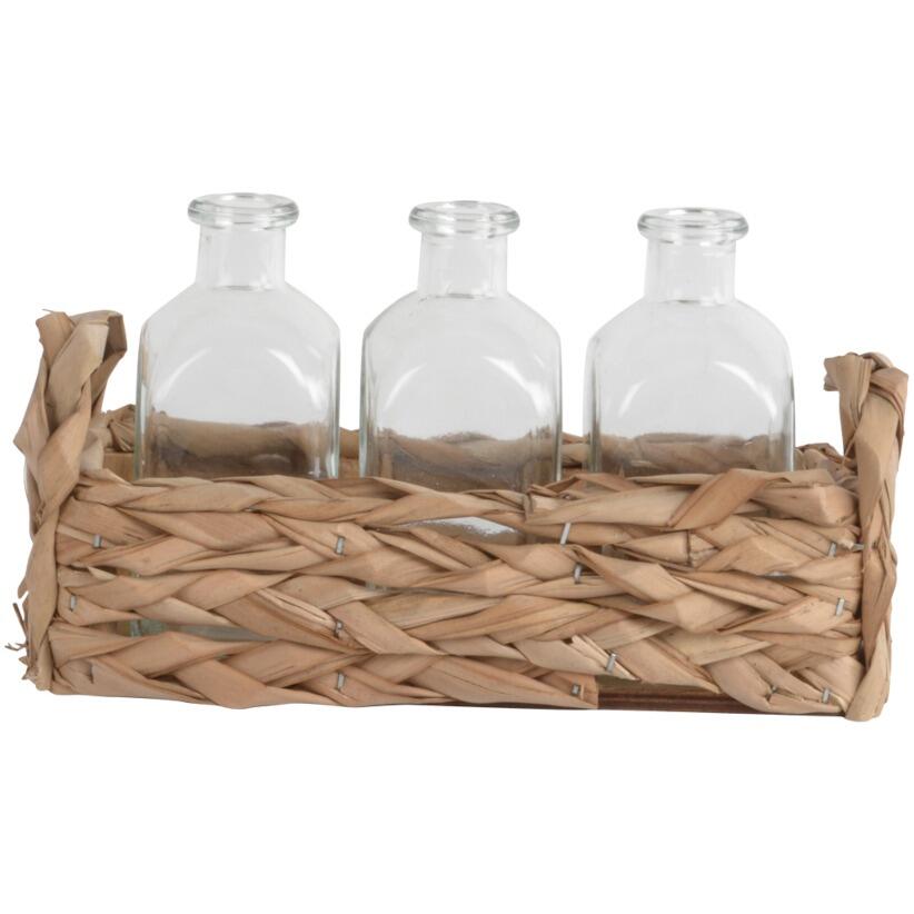 Handcrafted straw basket with three clear bottle vases