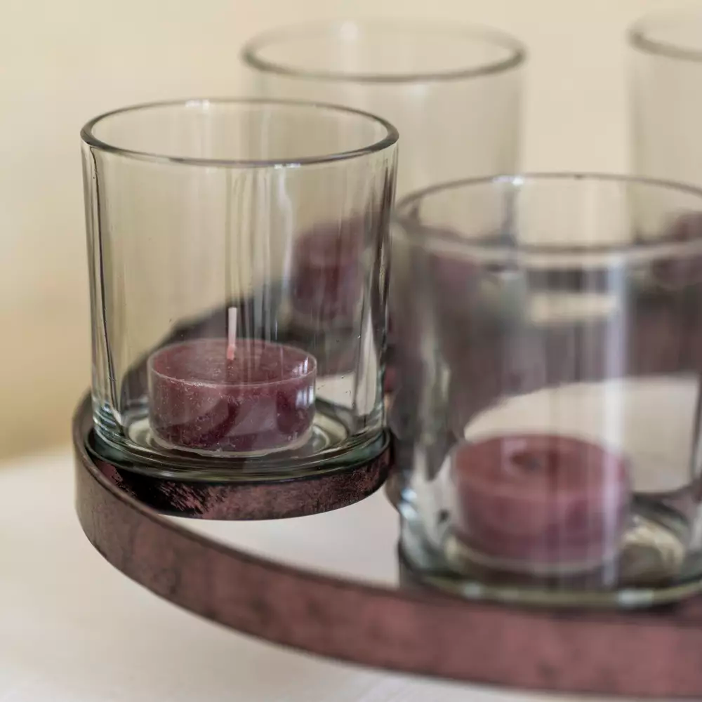 glass votive candle holder on a rustic metal frame
