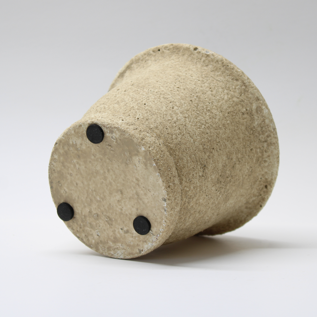distressed cement plant pot on it's side detailing the protective rubber pads