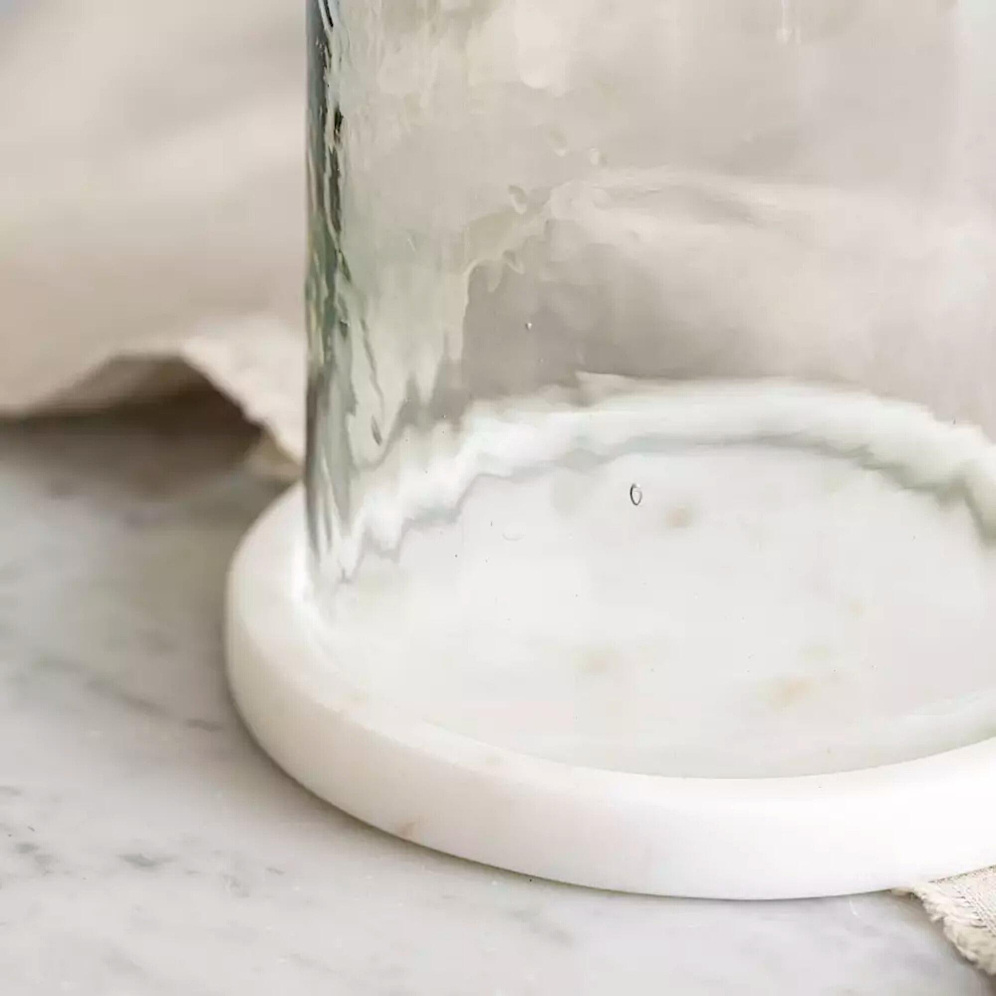 Closeup of hurricane lanterns solid white marble base.