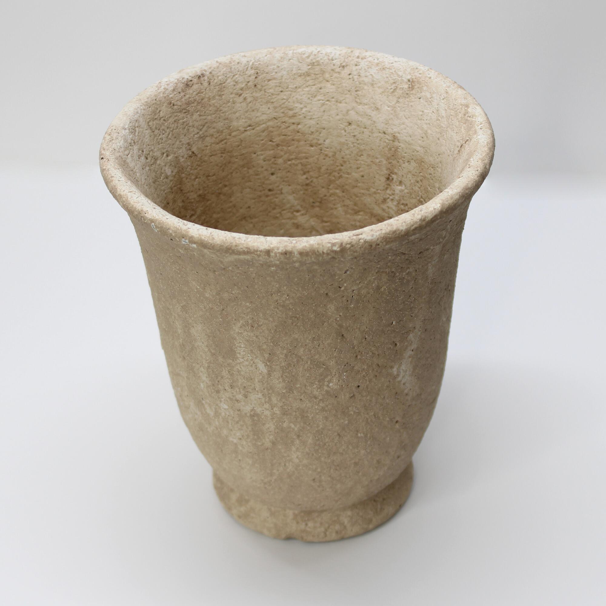 Cement urn pot with a coarse sandstone finish.