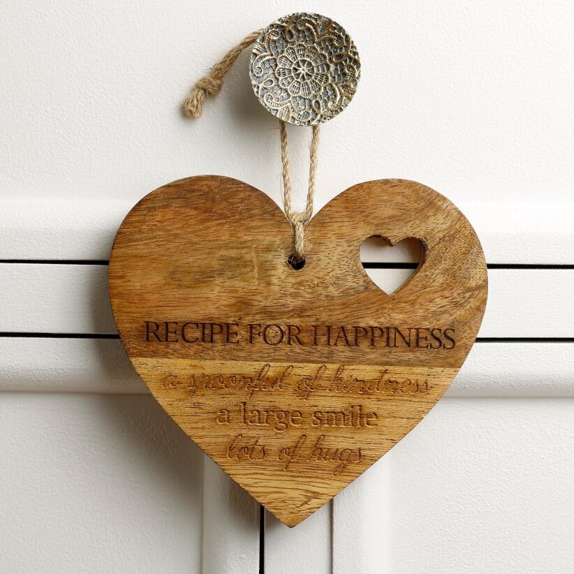 wooden hanging heart, adorned with the heartfelt words "Recipe for Happiness: A spoonful of kindness, a large smile, lots of hugs" hanging from draw handle