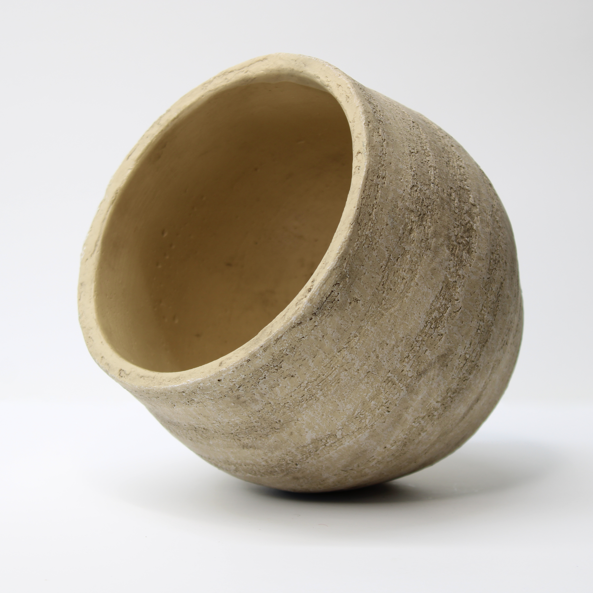 empty rustic indoor plant pot on its right side, showing the organic shape