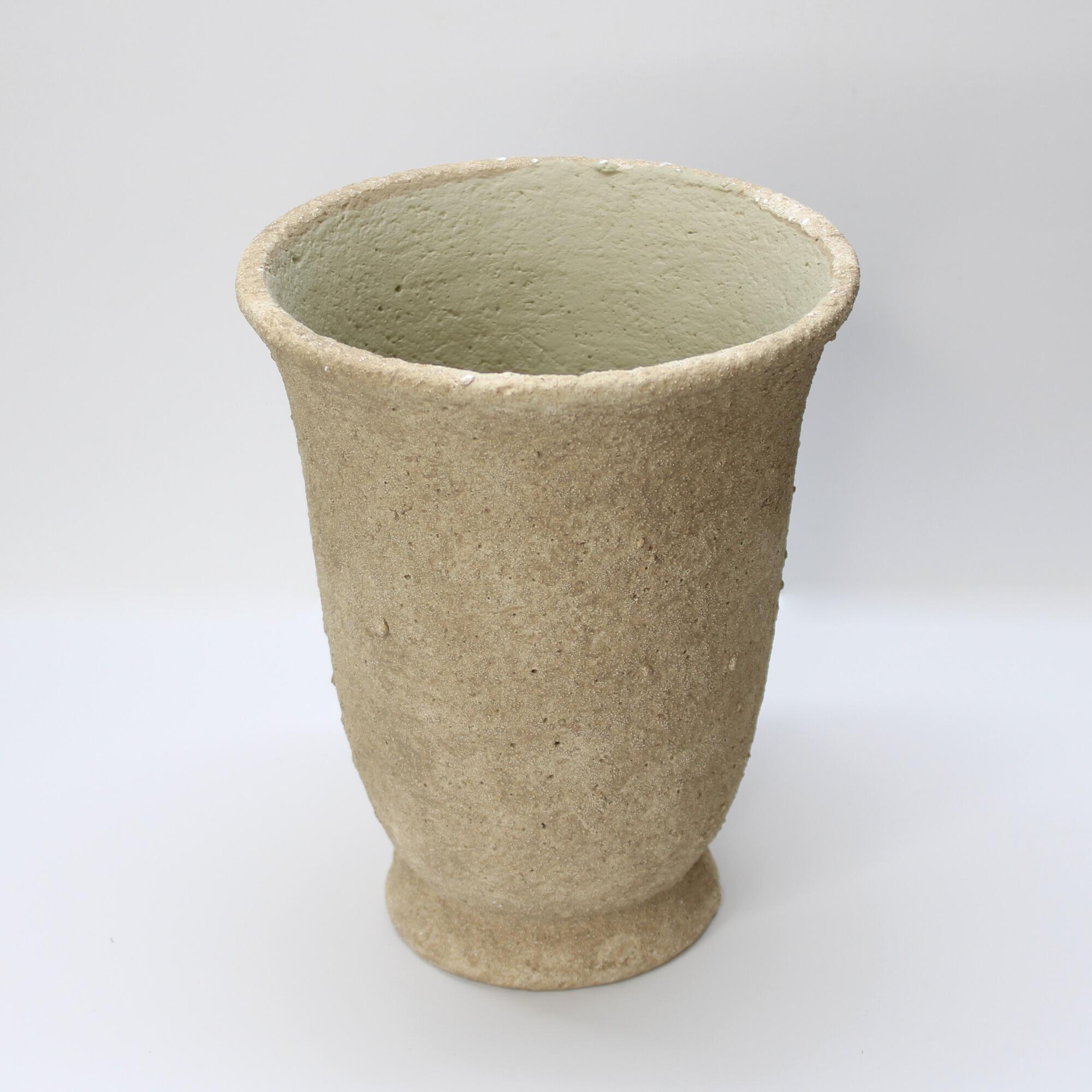 Rustic Wabi-Sabi style concrete urn with a flared rim and weathered pockmarked finish for indoor plants.