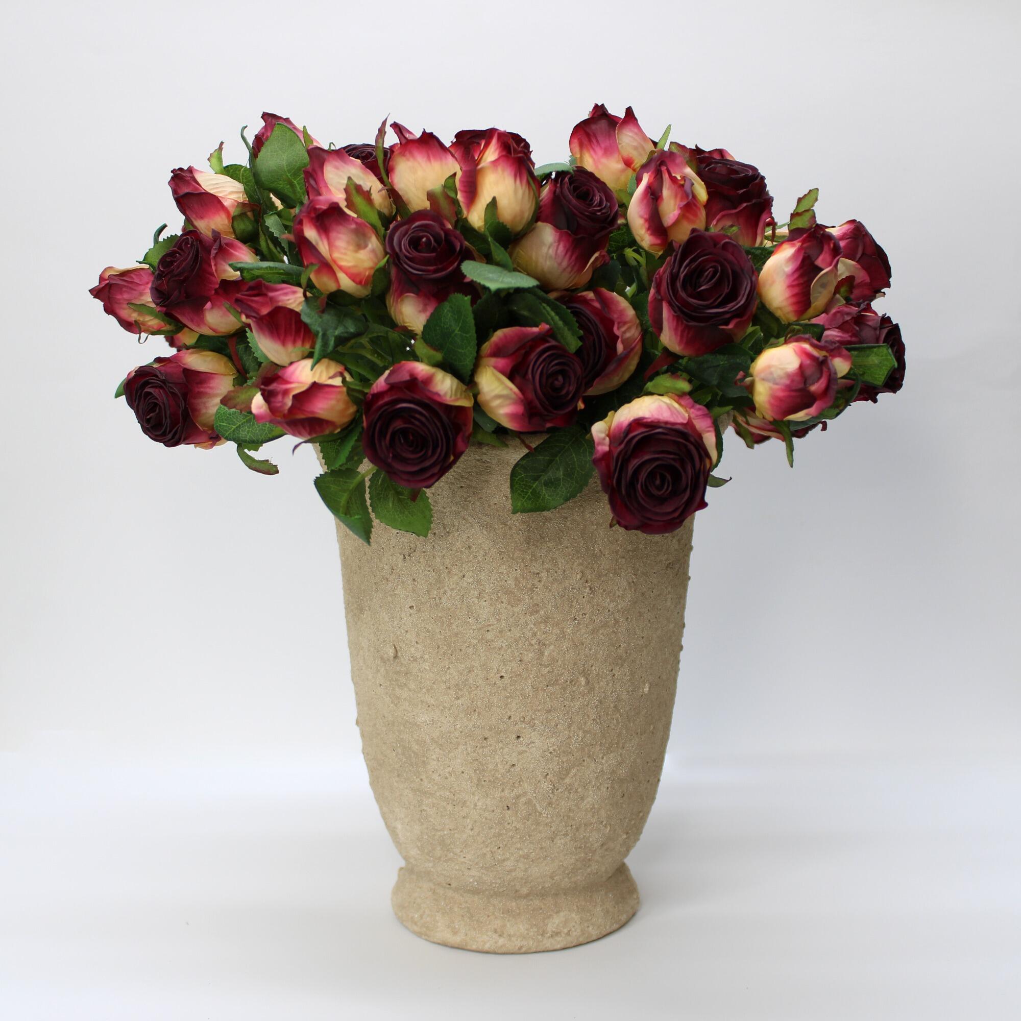 Rustic style concrete urn with a flared rim displaying vintage roses.