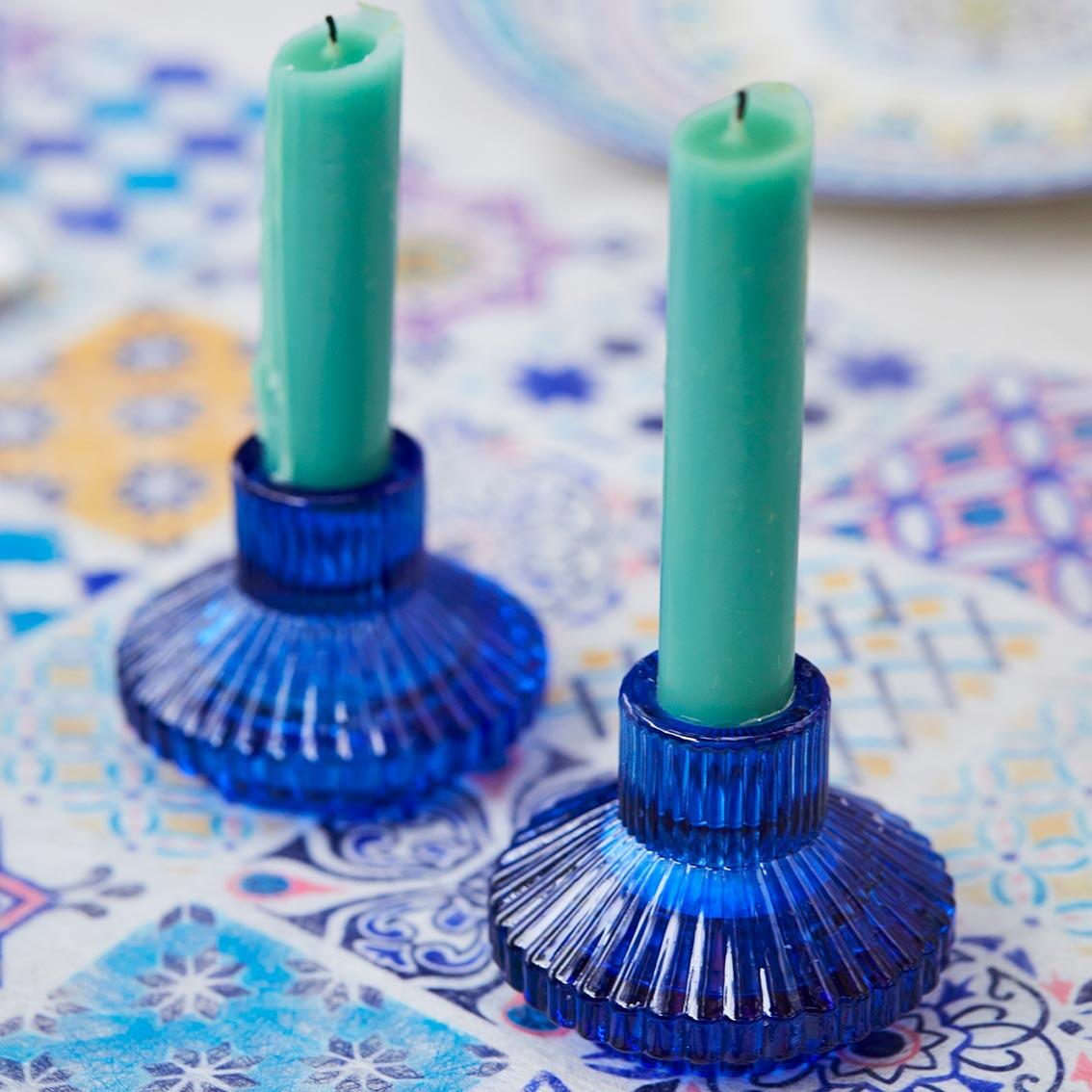 Small blue glass candle holders with candles