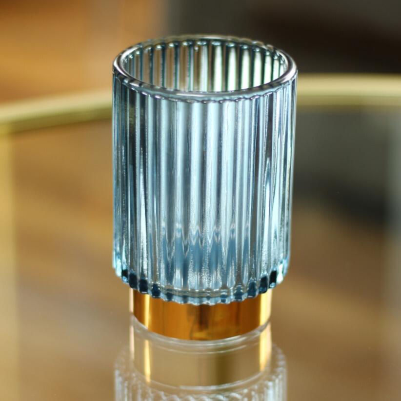 Tealight holder with blue ribbed glass on coffee Table