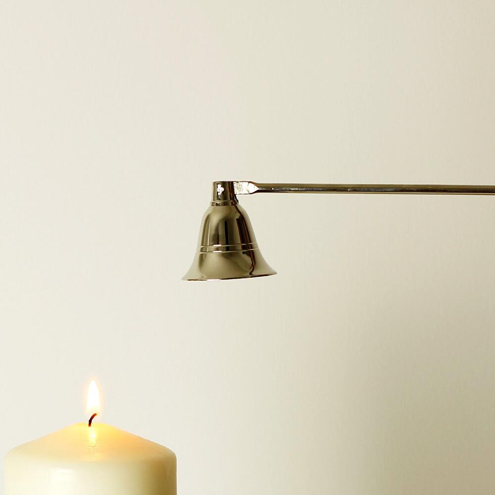 Silver candle snuffer putting out a candle