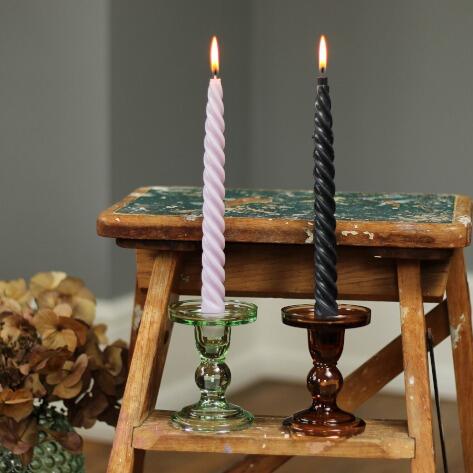 two glass candlestick holders on stepladders