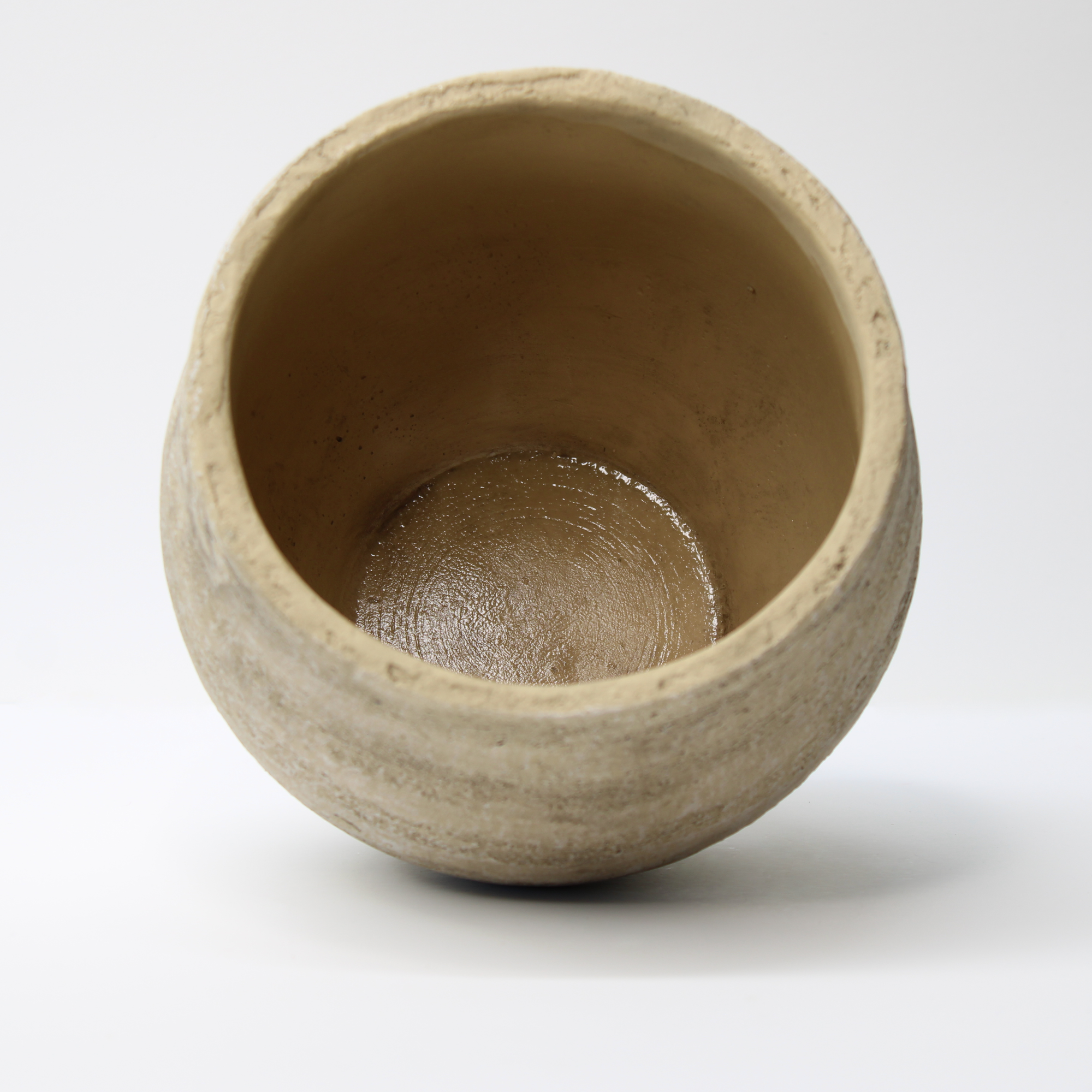 empty rustic indoor plant pot on its side, showing the internal finish
