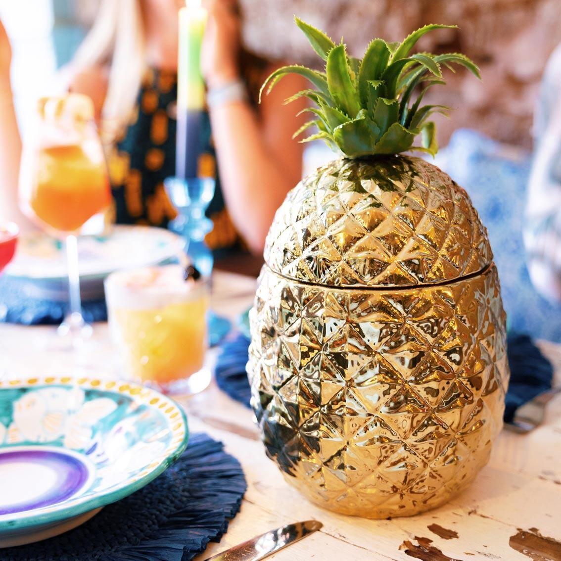 gold pineapple ice bucket on a party table