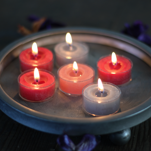 rustic coloured tealights on a vintage style candle tray.