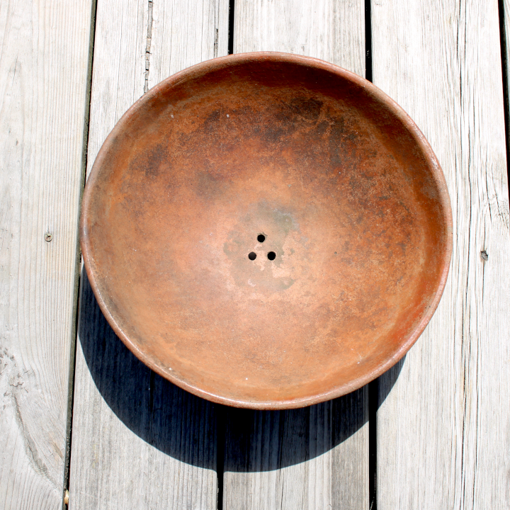 Terracotta bowl with newly drilled drainage holes, ideal for succulents.
