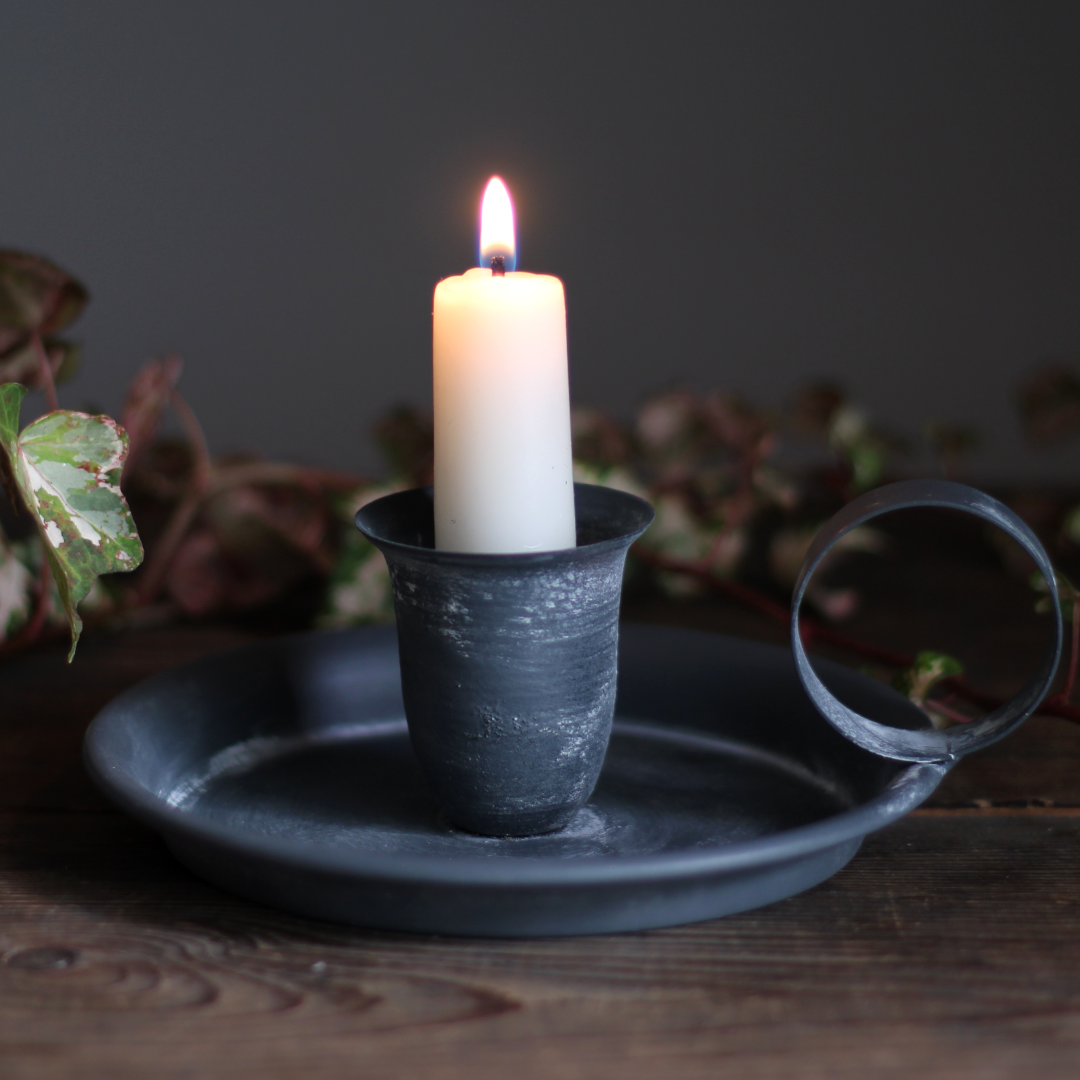 chamberstick with candle and rustic home decor setting