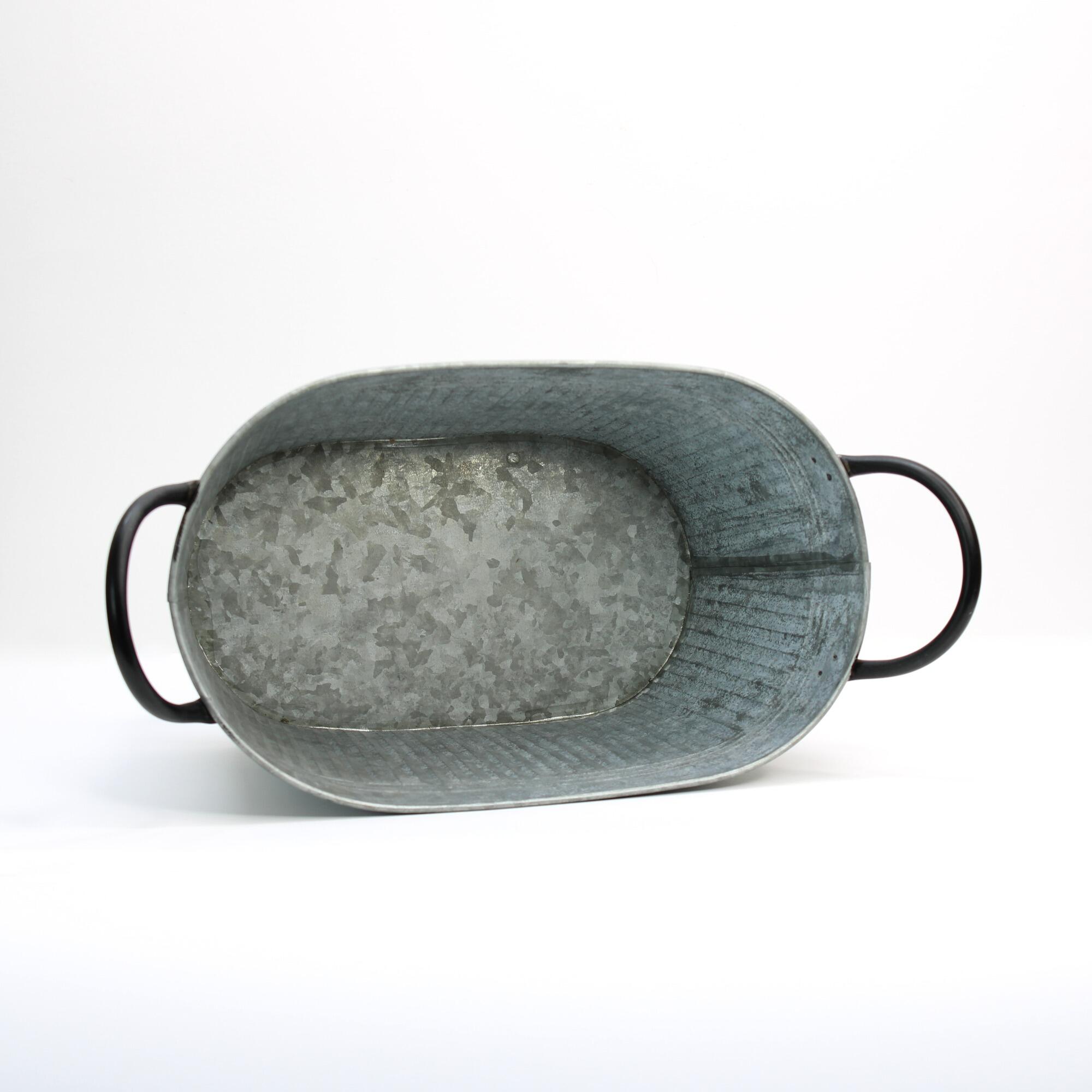 oval zinc planter tub focusing on the base
