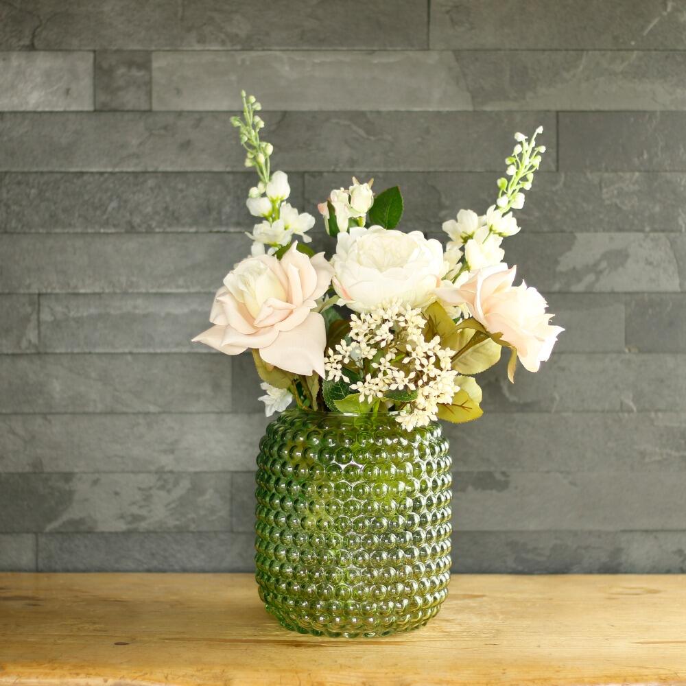 Green glass bobble vase with faux flowers