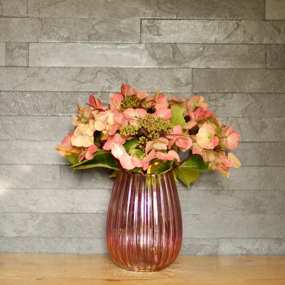 Pink glass vase with black slate background