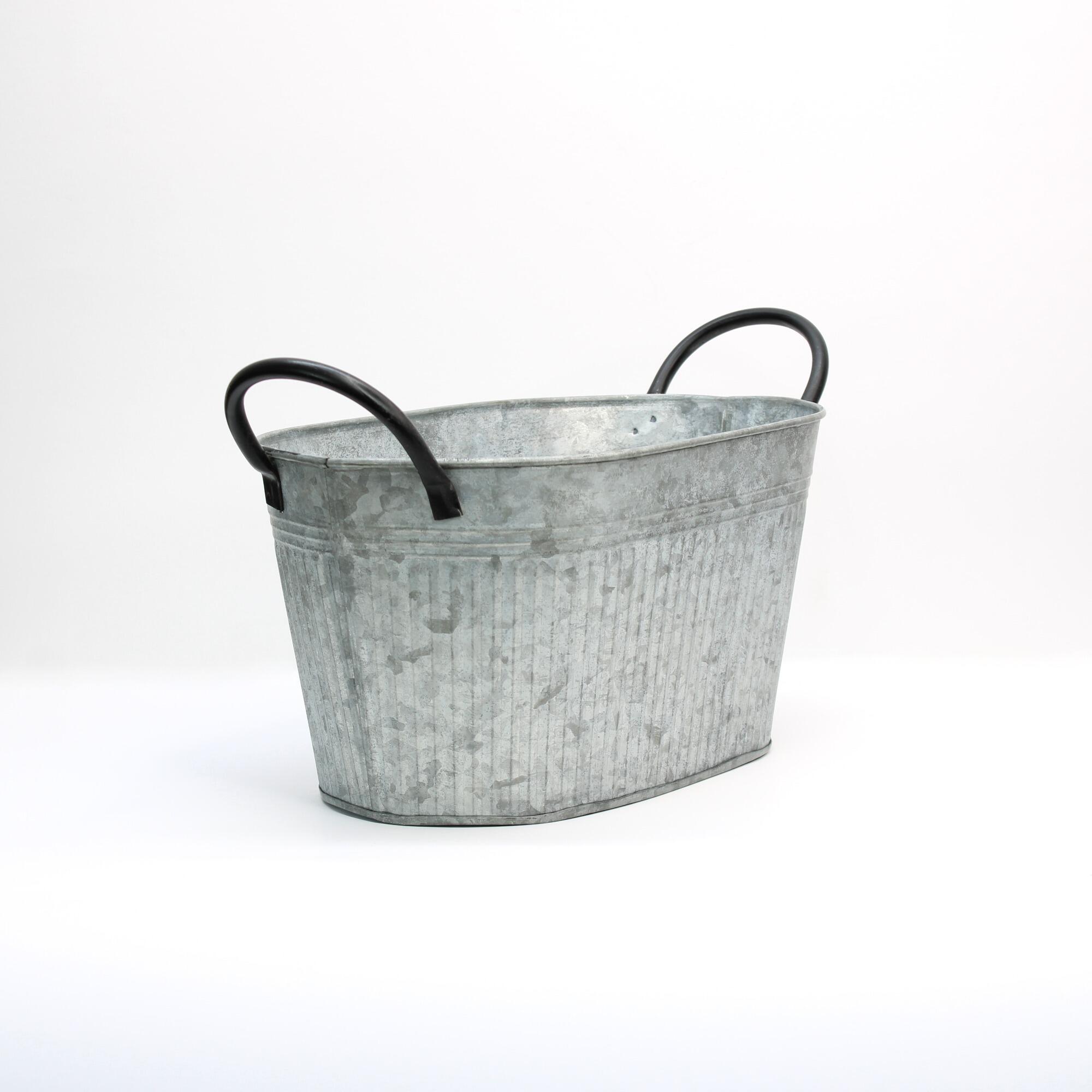oval zinc planter tub focused on the black handles