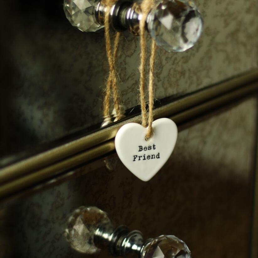 Cute ceramic heart-shaped hanging decoration features a heartfelt Best Friend message hanging from dressing table