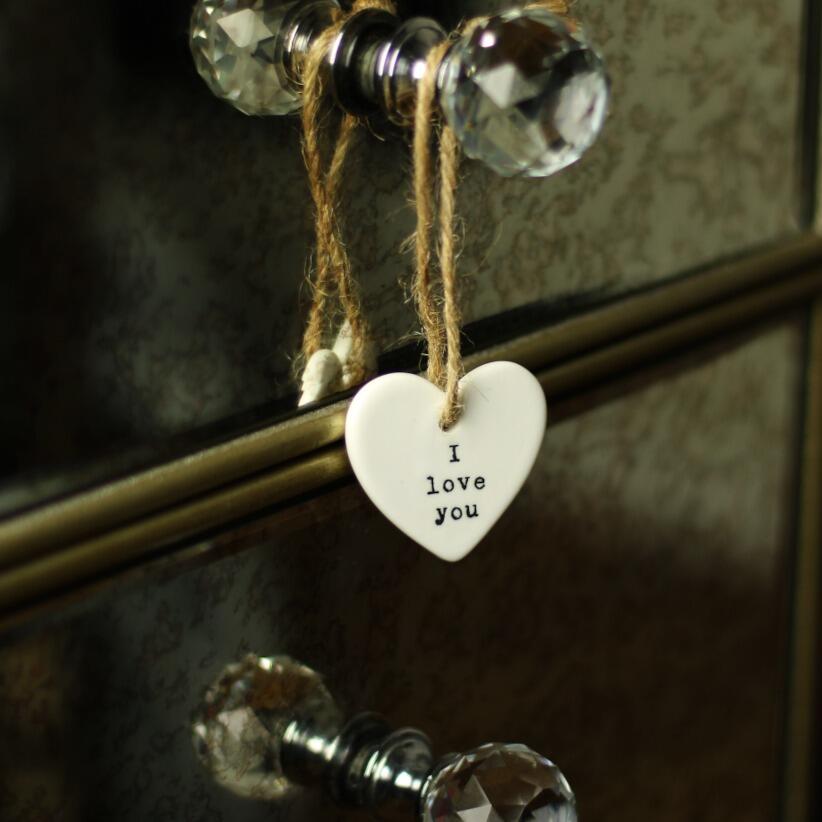 I love you dainty white ceramic hanging heart hanging from dressing table