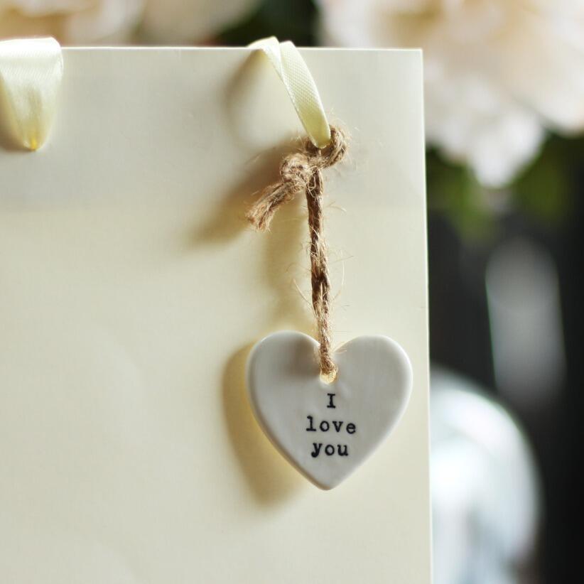 Mini hanging heart with the words i love you hanging from gift bag