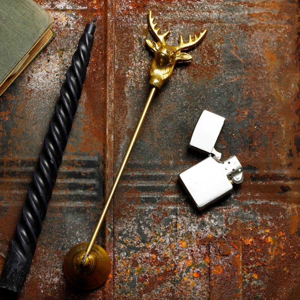 Candle snuffer with a gold rustic stags head