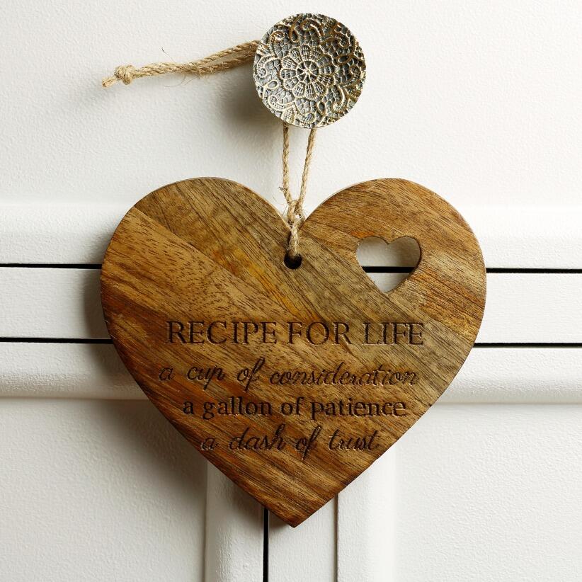wooden hanging heart, adorned with the heartfelt words "Recipe for Life: A cup of consideration, a gallon of patience, a dash of trust."  hanging from draw handle