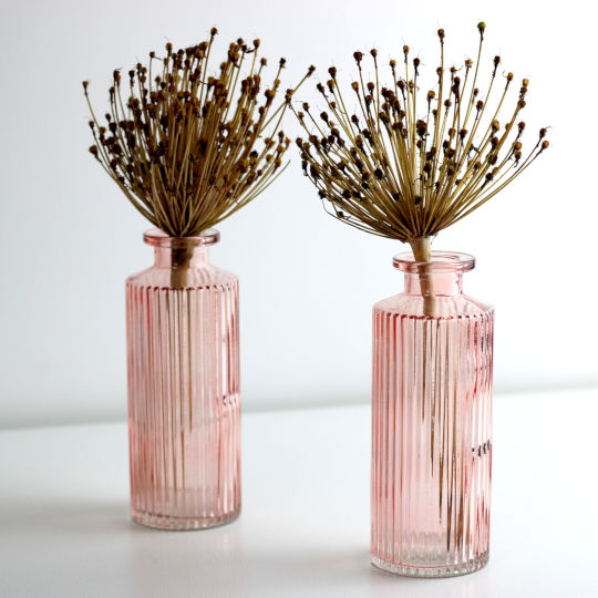 two small pink ribbed glass bud vases