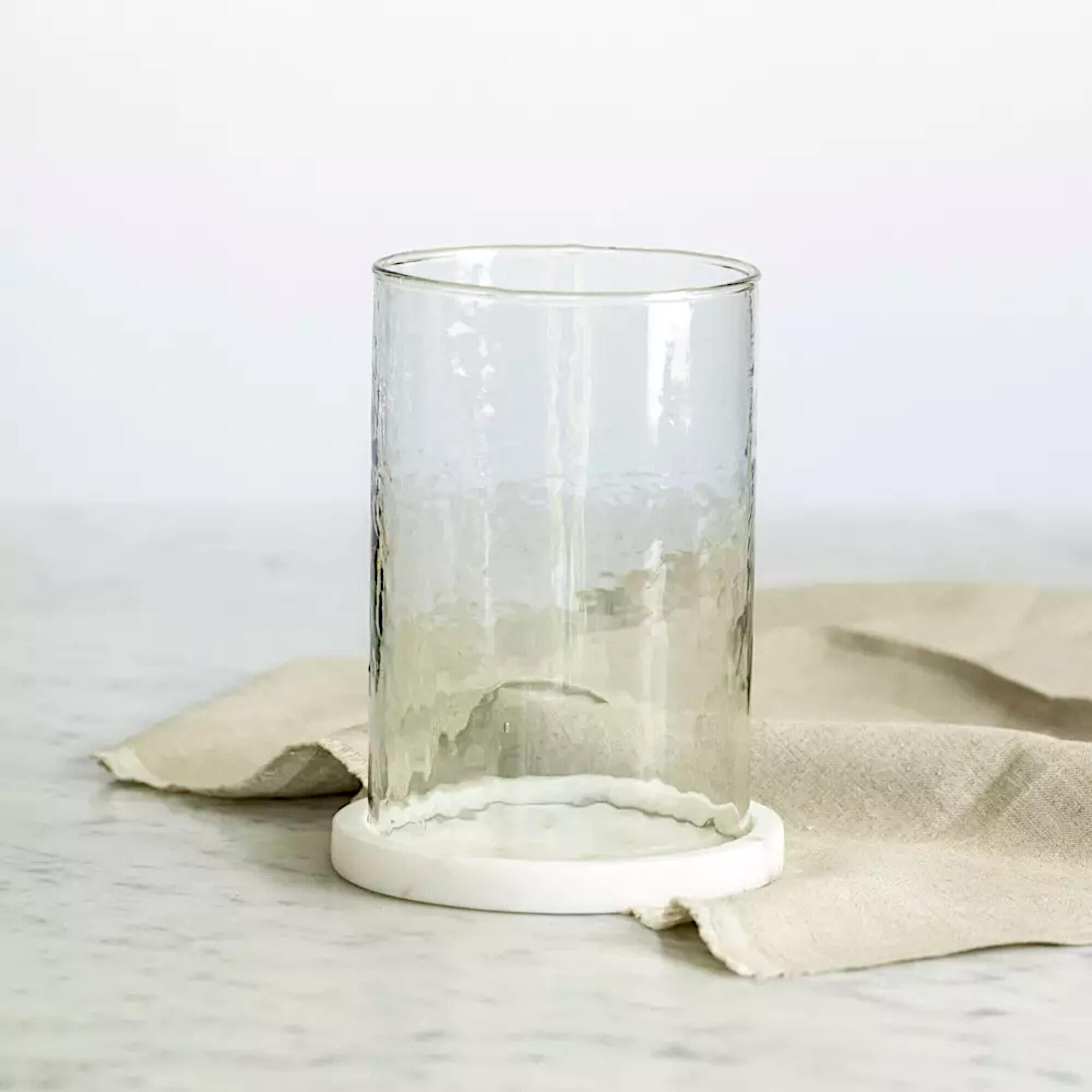 Hammered glass hurricane lantern with a solid white marble base.