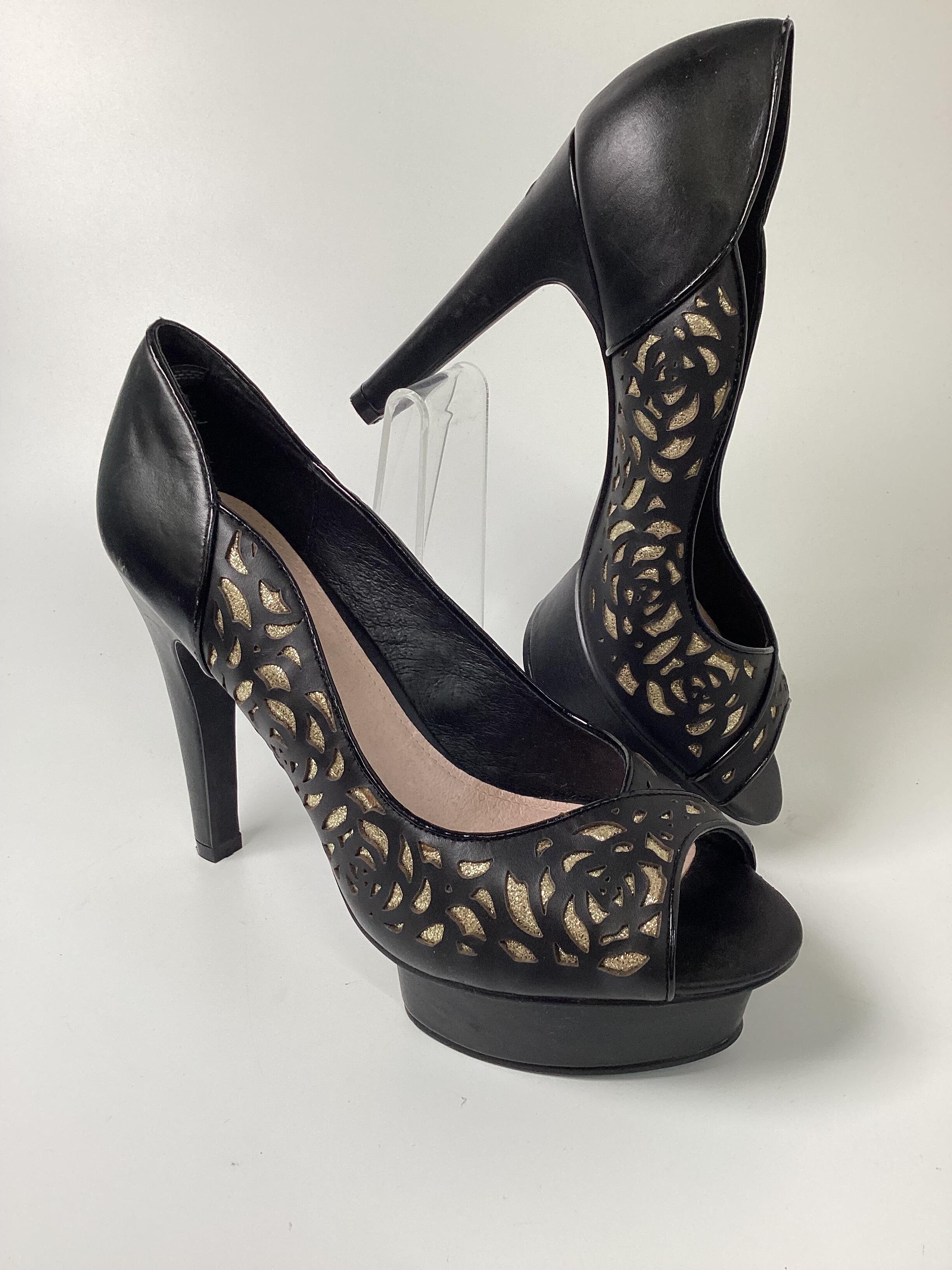 Kurt geiger black 2025 and gold heels