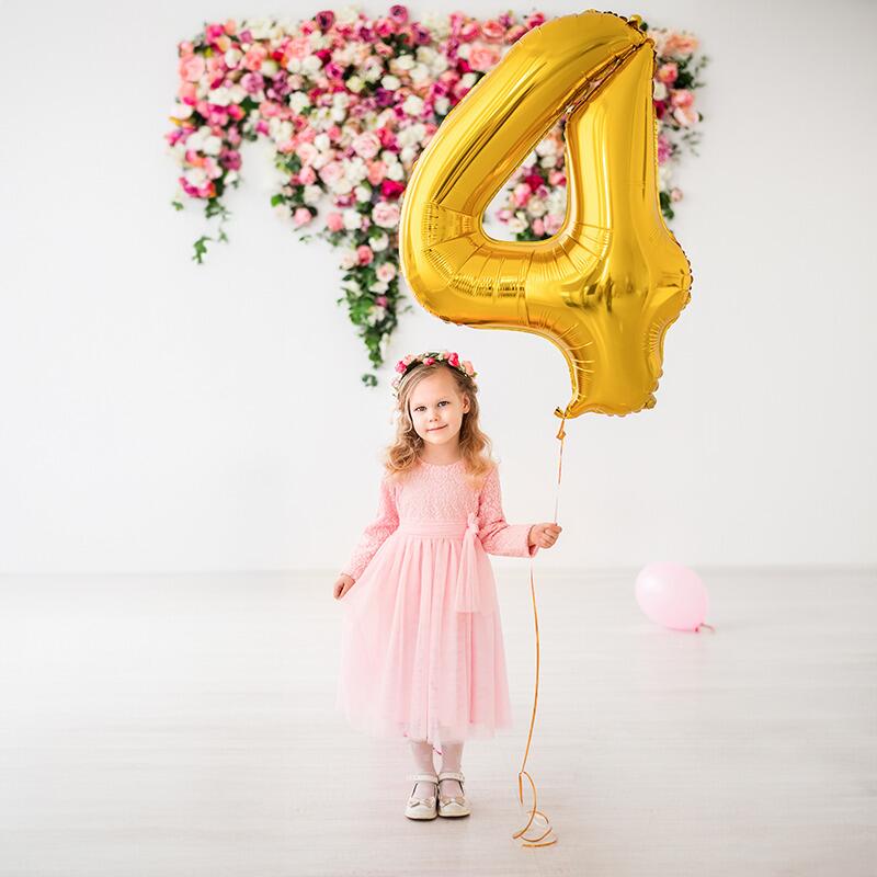 Girl holding a  34" Foil Number shaped Balloon filled with helium