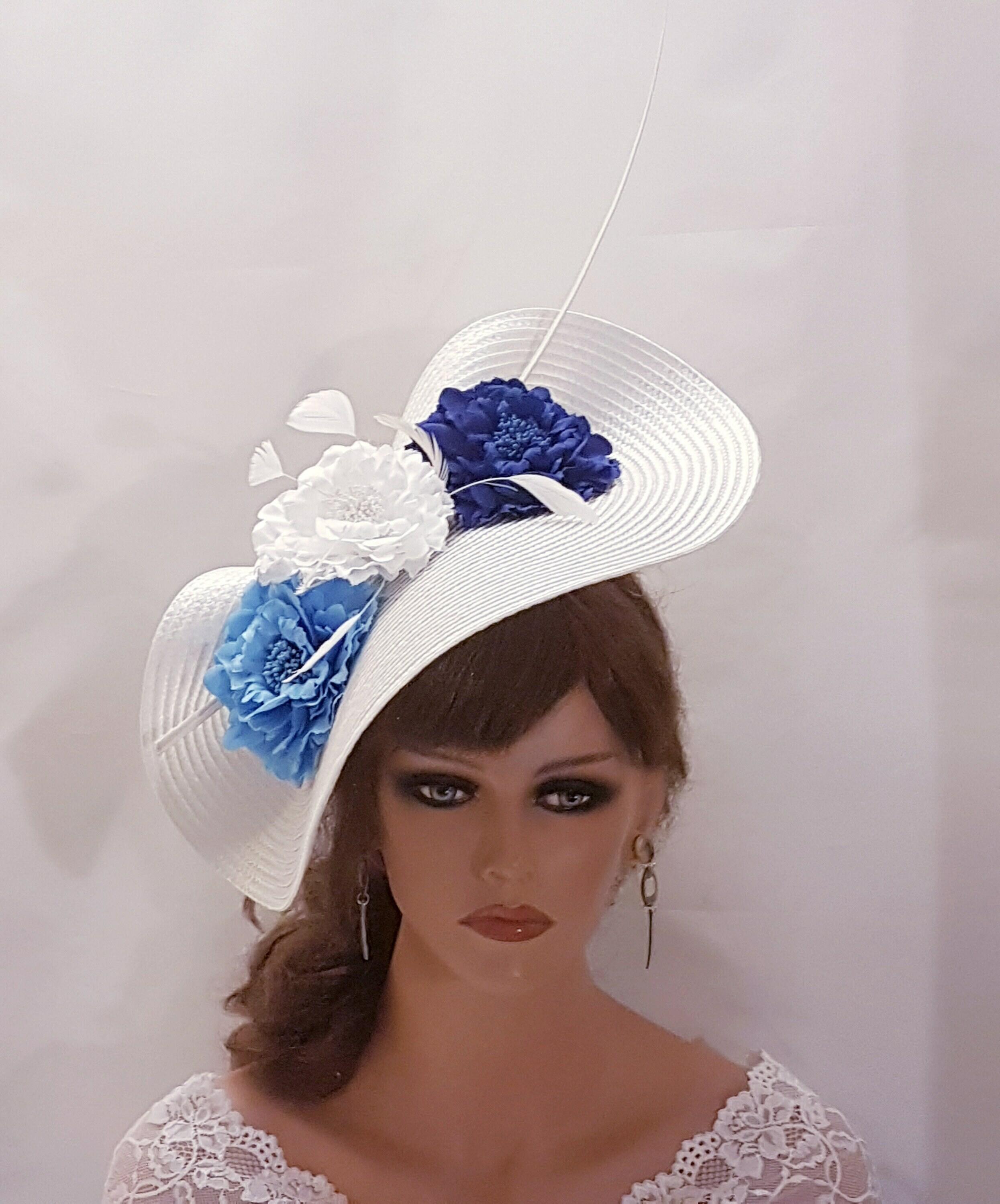 White hat fascinator with blue flowers