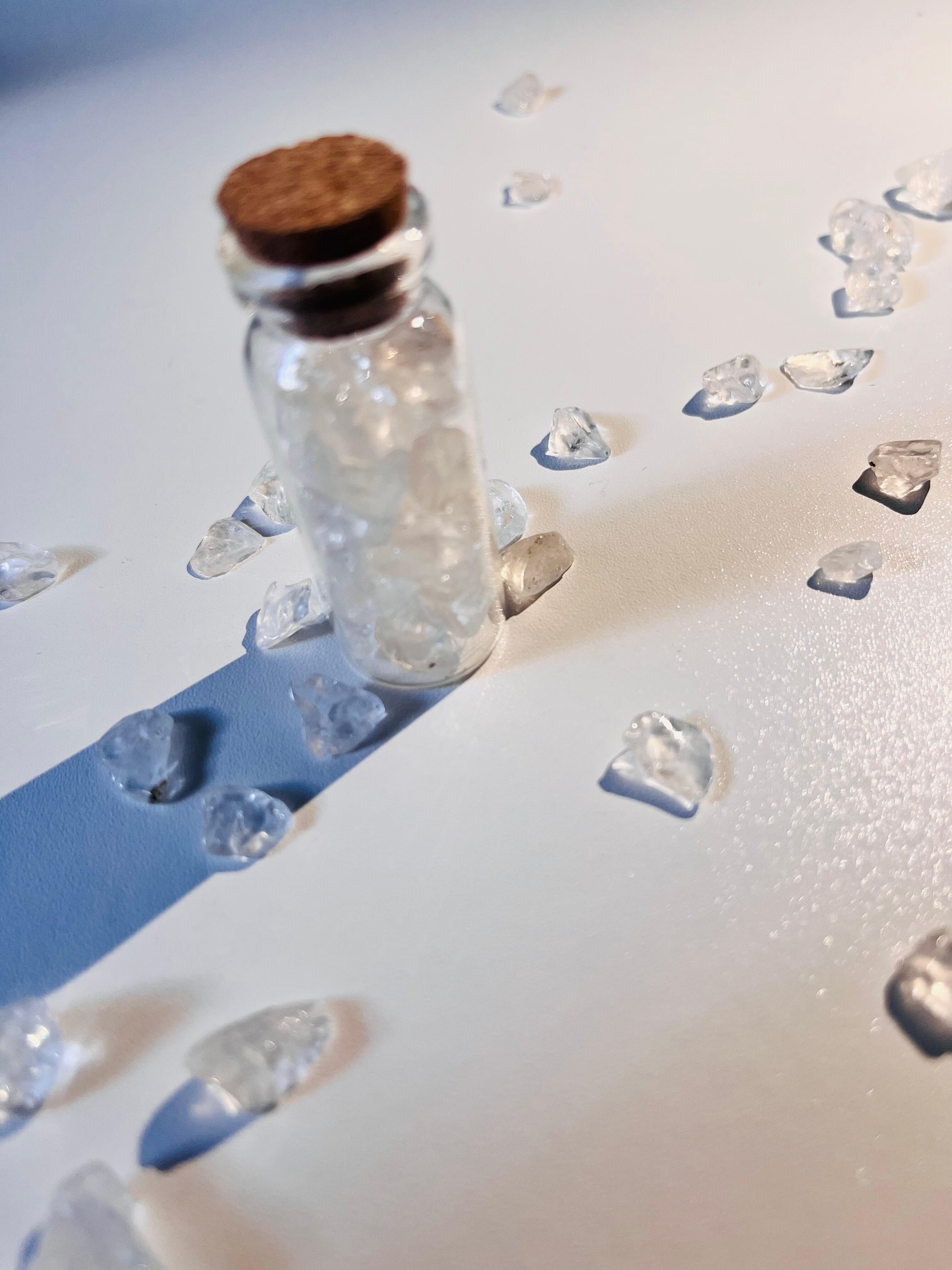 Clear Quartz jar with scattered crystal chips around it